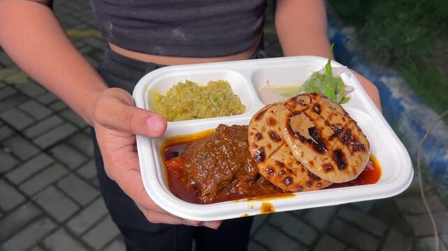 Litti chicken with chutney and chokha served in a street cart in India