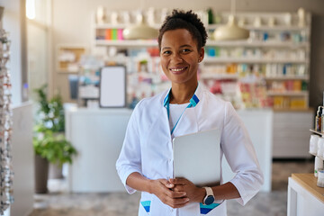 Portrait of happy black female pharmacist looking at camera.