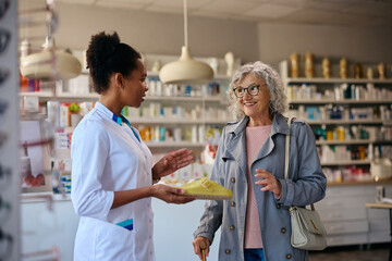 Happy senior woman talking to her pharmacist while looking for new anatomic footwear.