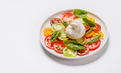 Fresh burrata served on slices of colorful tomatoes
