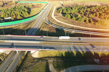 Aerial perspective of truck moving on highway through nature