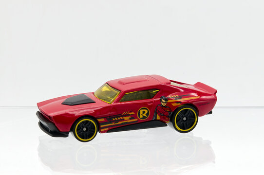 Bologna - Italy - October 22, 2025: Hot Whells die-cast muscle car toy with robin superhero graphics on white background.