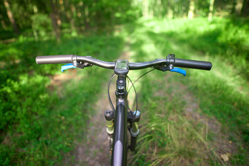 Handlebar view on off-road biking route