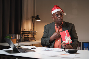 African american businessman receiving christmas gift in office