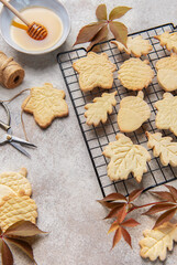 Autumn cookies on wire rack with honey and leaves