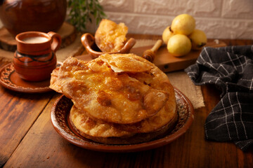 Mexican Buñuelos. Traditional food at Christmas and winter holidays in Mexico, these are fried flour tortillas sprinkled with sugar or covered in a syrup made with piloncillo, cinnamon, and guava.