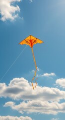 Bright orange recreational flyer soars high against a clear blue sky filled with white clouds