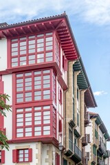 Traditional Basque Architecture With distinctive Colorful Wooden Balconies, historic building facades