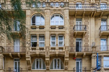 Belle Epoque Architecture, Stone Building Facade With Ornate Stone Carvings and Arched Windows © ikuday