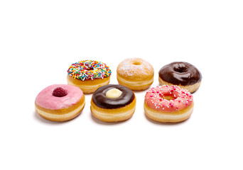 Delicious iced ring donuts with colorful sprinkles isolated on white background.
