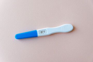 positive pregnancy test with two lines on soft pink background. Minimal medical concept symbolizing fertility, healthcare, and reproductive diagnostics. Clean and neutral composition.
