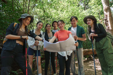 Young asian hikers planning forest trail with map