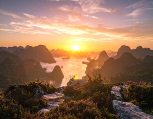 Scenic panoramic view of sunrise over hazy mountain peaks and water