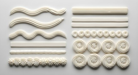 Set of different white piped buttercream frosting borders and decorative textures isolated on white