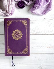 Purple ornate book with gold detailing on a white wood surface