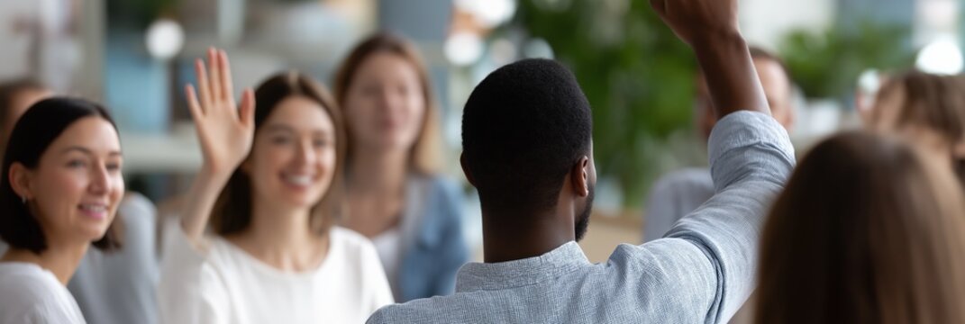 Diverse group discussion with engaged participants raising hands in office setting