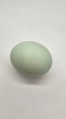 Salted eggs that are still whole and those that have been cut in half show the red inside, isolated on a white background.