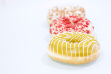 Delicious glazed donuts on white background.