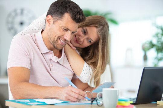 happy couple checking accountancy at home