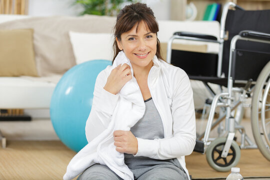 a woman in a wheelchair smiling at the camera