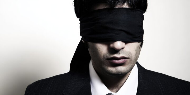 Man blindfolded, symbolizing ignorance, censorship, and lack of vision