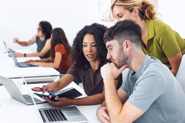 Fototapeta premium Business people working with laptop and talking of they new project together in a coworking place