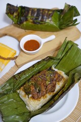grilled banana leaf rice nasi bakar with spicy filling for traditional indonesian food photography
