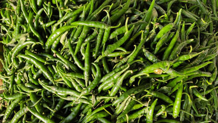 Close up shot of fresh green chili peppers showing natural texture freshness and organic farming concept