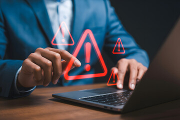 it security concept with an analyst reviewing system warnings and threat alerts