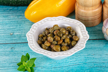 Pickled canned capers in the bowl