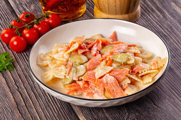 Italian pasta farfalle with salmon