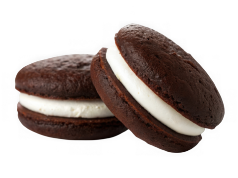 Two chocolate whoopie pies with cream filling isolated on transparent background