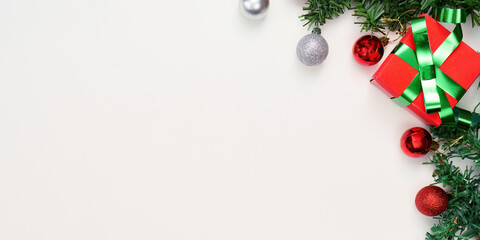 Christmas gift box and ornaments on a light background