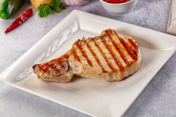 Tasty hot grilled bone steak served sauce