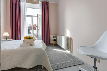 Bright Bedroom with Balcony and Pink Curtains in Modern Apartment