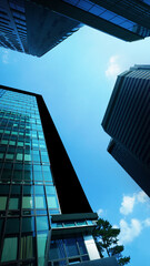 Modern urban skyscrapers towering against clear blue sky in a metropolitan city