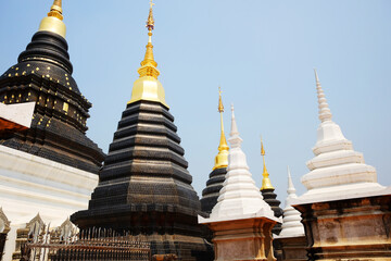 Fototapeta premium Ancient white and black with golden pagoda symbols of buddhism at Wat Den Sali Si Mueang Kaen temple in Chiang Mai Province in Thailand