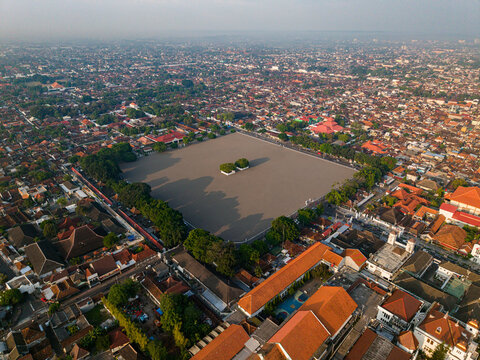 Aerial view of Alun-Alun Utara's expansive square, a tranquil void amidst the vibrant cityscape, Yogyakarta, Jawa Tengah, Indonesia.