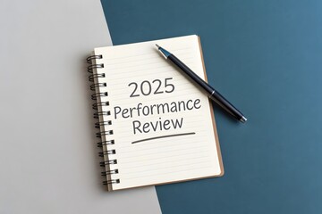 A notebook with 2025 performance review and a pen