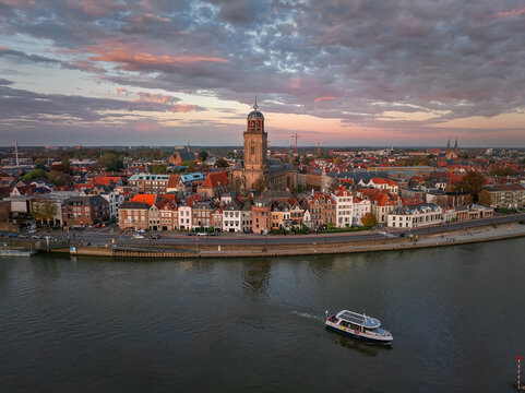 Aerial view of the majestic Lebuinus Church standing tall amidst the charming cityscape, reflected in the calm waters, Deventer, Overijssel, Netherlands.