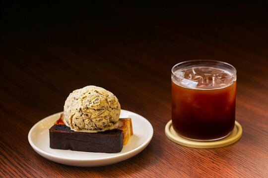 Delicious dessert and cold drink served at a cozy cafe table during afternoon break