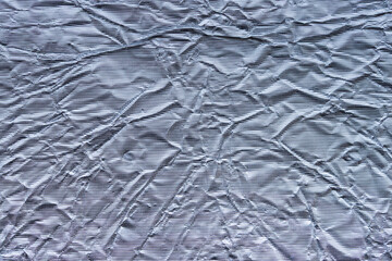 Shiny metal silver gray foil leaf crumpled texture background