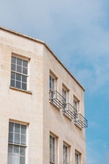 Brick building in the historic city with blue sky in background of Bath, UK, Showcasing its intricate architectural details and beauty.