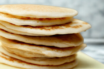 Stack of delicious golden brown pancakes close up