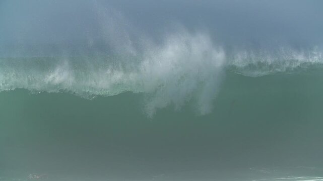 Huge empty storm wave breaking on the beach