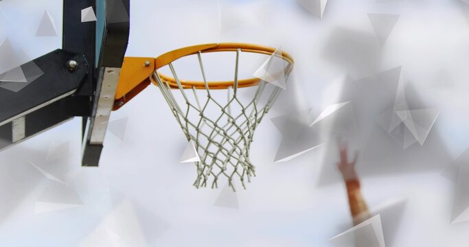 Fototapeta Showing basketball hoop orange rim and net on black support arm at outdoor court, orange wristband