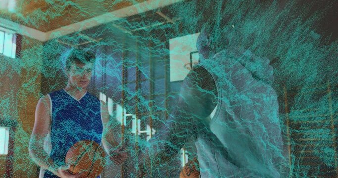 Coach in gray hoodie guiding athlete in jersey holding basketball on court, with holographic grid