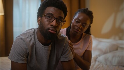 African American married family ethnic couple quarrel argument conflict guilty woman wife comforting calming ask for forgiveness annoyed man husband shaking head no never reject at home bedroom night