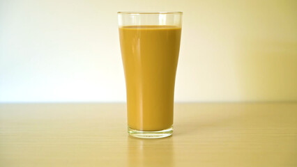 Glass of Creamy Coffee with Milk on Wooden Table with Copy Space