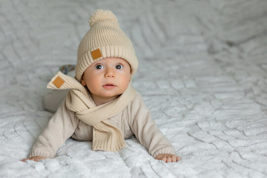 Cute adorable happy baby child with warm knitted hat - Powered by Adobe